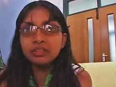 A Young Woman Of Indian Descent Wearing Eyeglasses And Looking Away With A Thoughtful Expression On Her Face.