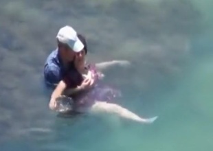 Voyeur captures a couple having sex in the sea