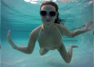 Undefiled unexcelled model in a bikini goes for a swim in the pool