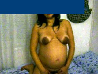 This preggo wife with beautiful cinnamon skin is about 8 months pregnant. She shows her big abdomen and her breasts are nude - her areolas are very dark and large.