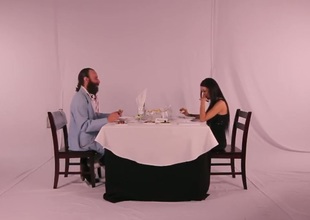 Gorgeous brunette lady with attractive long hair invited by elderly bearded businessman at the beautiful romantic dinner in the restaurant. But something goes wrong.