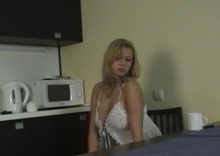 Sexy blonde in the kitchen wearing lingerie and masturbating