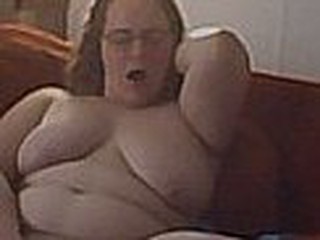 Chubby babe masturbates on sofa