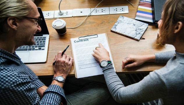 Two People Going Over a Contract Together