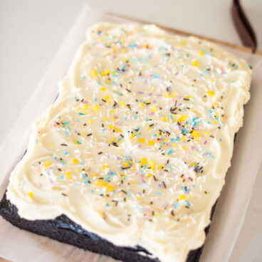 Chocolate sheet cake on a cutting board.