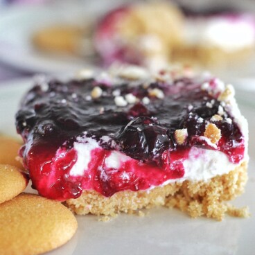 Grandma's Blueberry Delight - no-bake, layered dessert made of Nilla wafers, whipped cream and blueberry compote. #cakebycourtney #blueberrydelight #nobakedessert #layereddessert