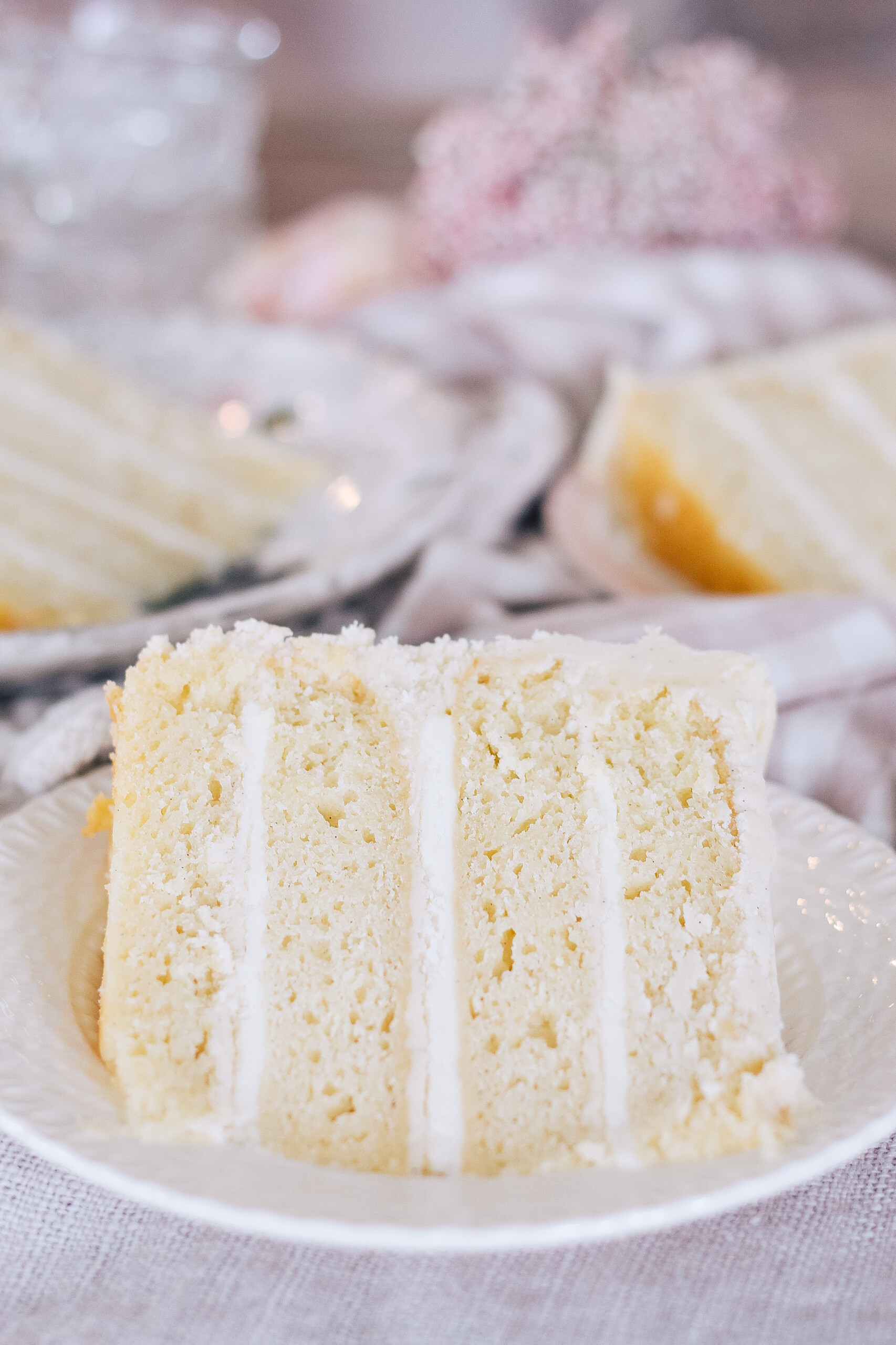 A slice of a four layer cheese danish cake on a plate.