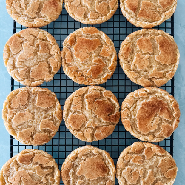 Snickerdoodle cookies on a cooling rack.