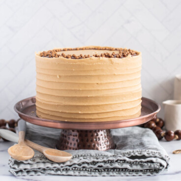 Snickers Cake on a cake stand.