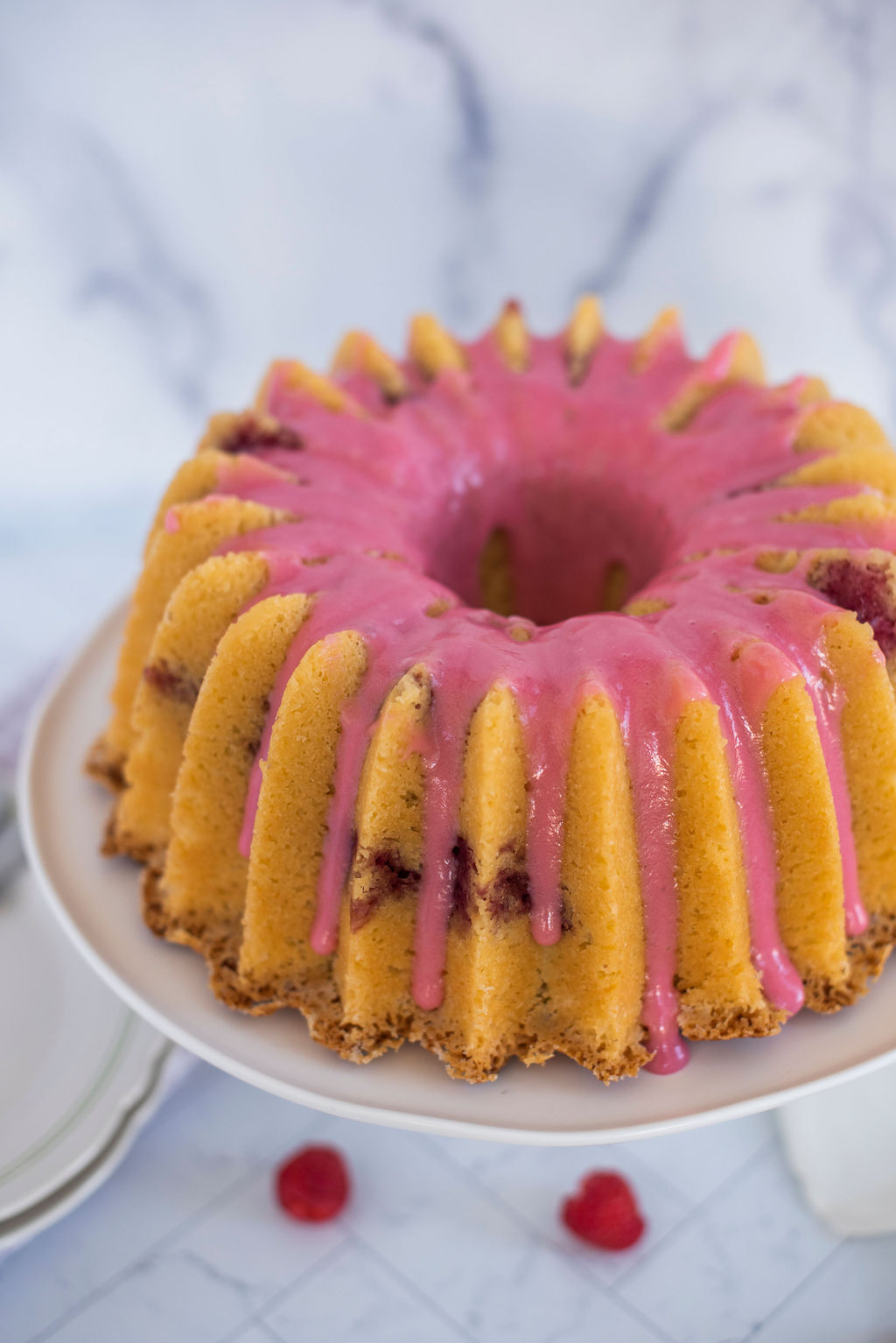 Raspberry Cheese Danish Bundt Cake on a cake stand.