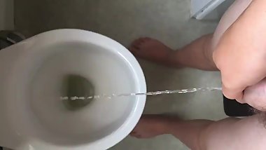 Young teen boy pissing in toilet