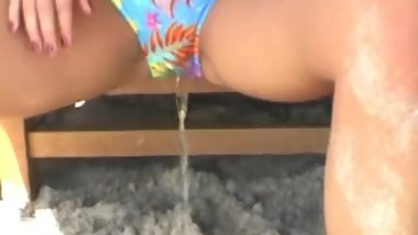 bikini pissing on the beach