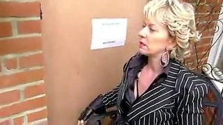 Milf in boots enjoys public gloryhole blowjob