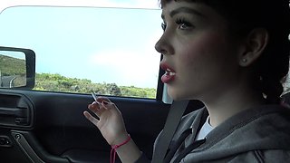 Cute brunette babe Aliya Brynn smoking a cigarette in the car