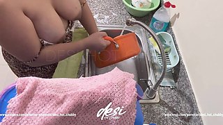 Indian Desi Bhabhi Was Working in the Kitchen Washing Dishes and Showing Her Big Boobs