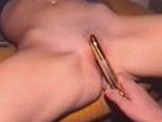 Charming wife gets her shaved slit filled with golden sex-toy, which her husband pokes into her dripping twat.